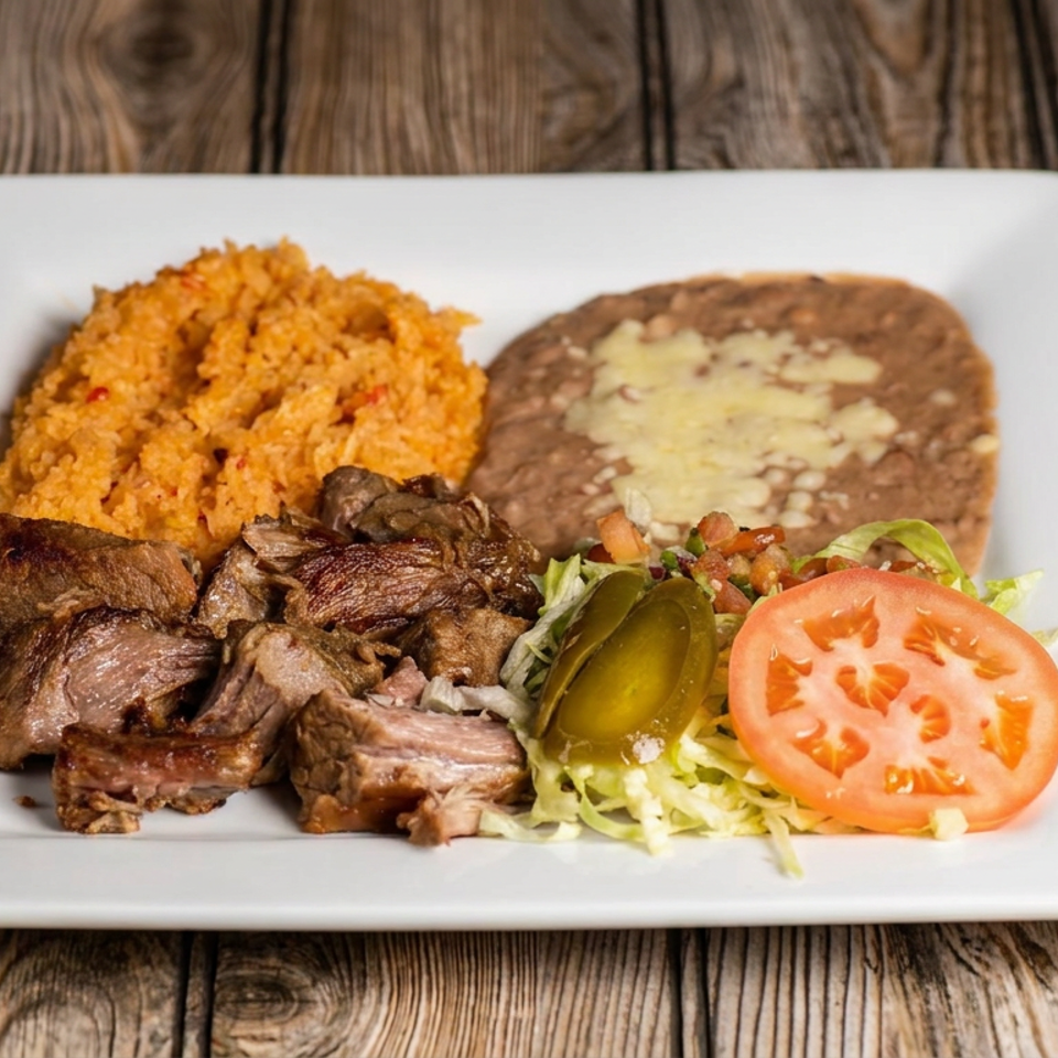 Plated Mexican meal with grilled meat, orange rice, refried beans, lettuce, tomato, and jalapeño on a white dish.